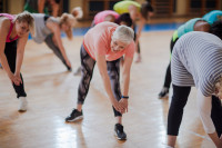 Group of people stretching in an exercise class