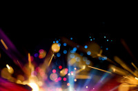 image of colorful sparklers on a dark background