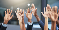 Image of raised hands of various ethnicities
