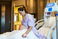 Pregnant person in hospital ward