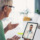 Senior woman talks to her doctor through a video call 