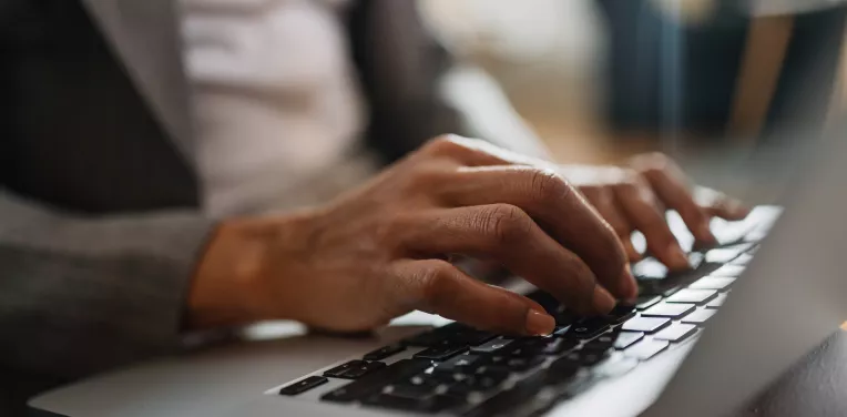 Woman typing on a laptop