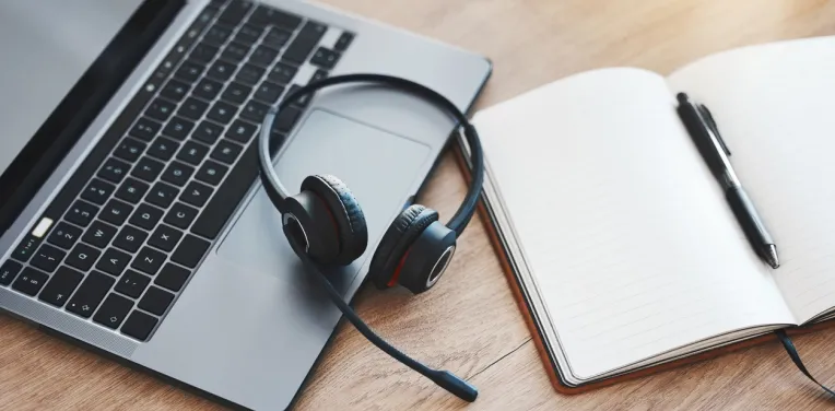 Laptop, notebook and headphones for call center, customer service