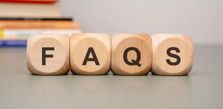 Wooden blocks spelling FAQs
