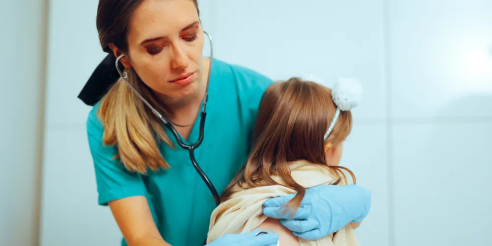 Doctor consulting a child with a stethoscope