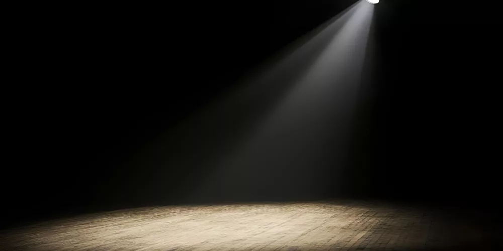 A spotlight shines on an empty stage