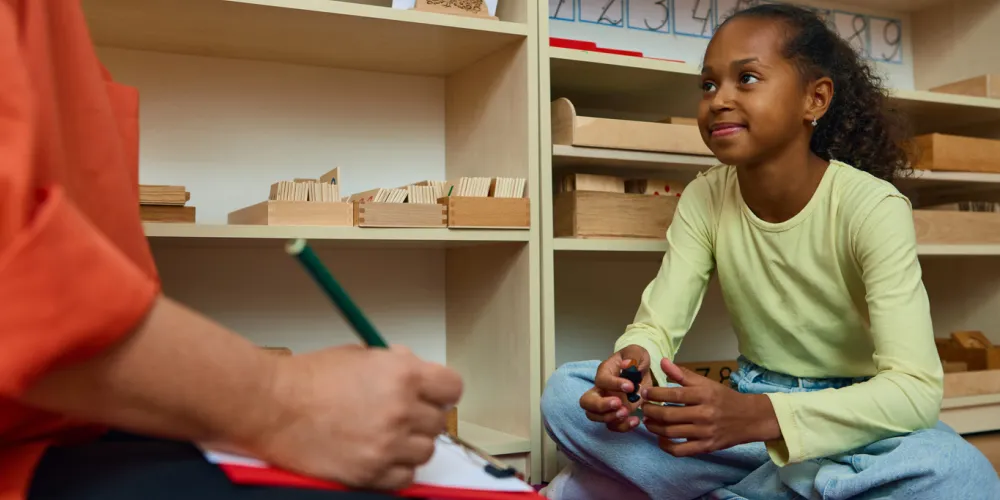 Girl talking with child psychologist in therapy session