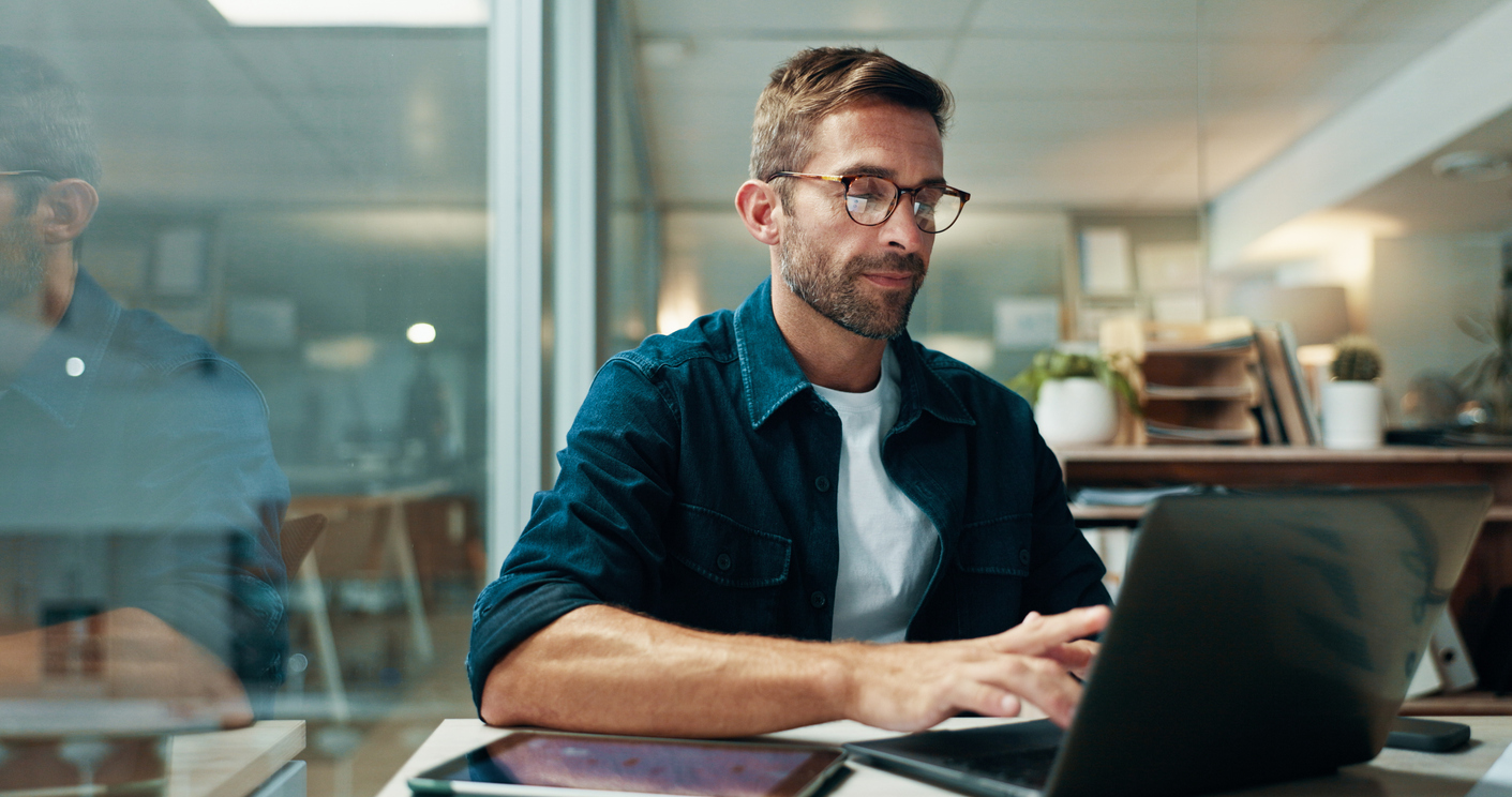 man typing on laptop